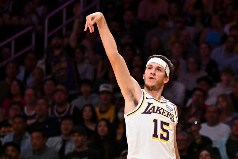 Mar 22, 2025; Los Angeles, California, USA; Los Angeles Lakers guard Austin Reaves (15) shoots against Chicago Bulls center Nikola Vucevic (9) during the first half at Crypto.com Arena. Mandatory Credit: Jonathan Hui-Imagn Images