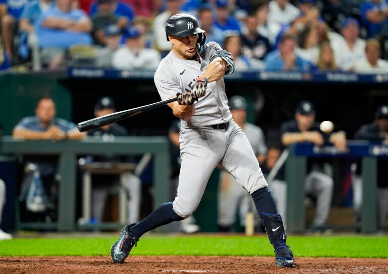 New York Yankees designated hitter Giancarlo Stanton (27) hits a single during the sixth inning against the Kansas City Royals in game three of the ALDS for the 2024 MLB Playoffs at Kauffman Stadium.