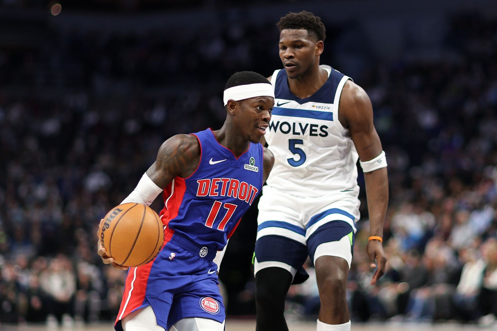 Detroit Pistons guard Dennis Schroder (17) works around Minnesota Timberwolves guard Anthony Edwards (5) during the first quarter at Target Center.
