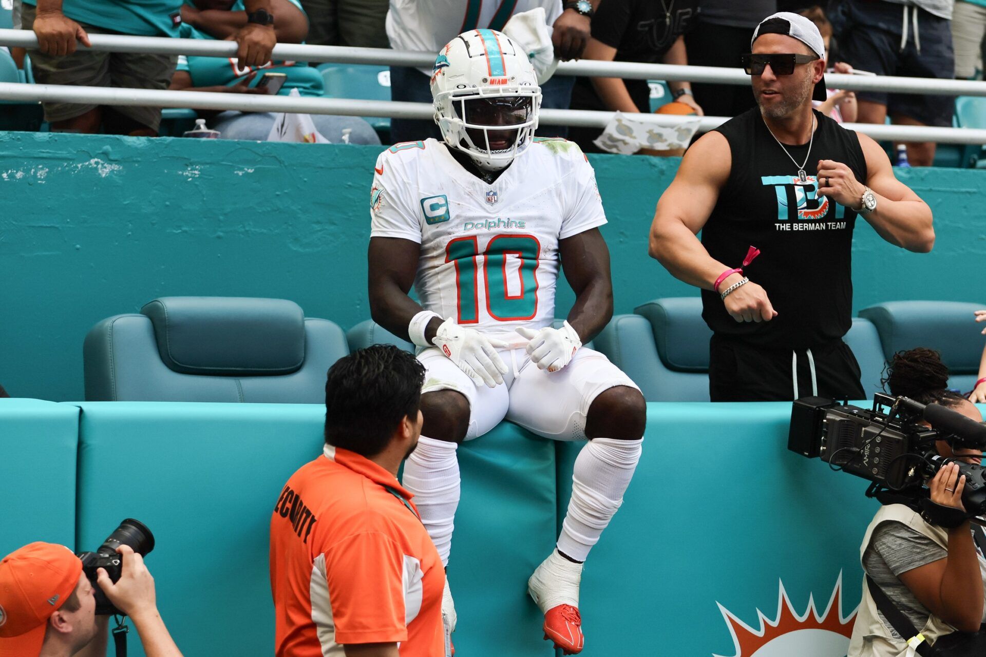Miami Dolphins wide receiver Tyreek Hill (10) sits on the stands after running out of bounds against the Arizona Cardinals during the second quarter at Hard Rock Stadium.