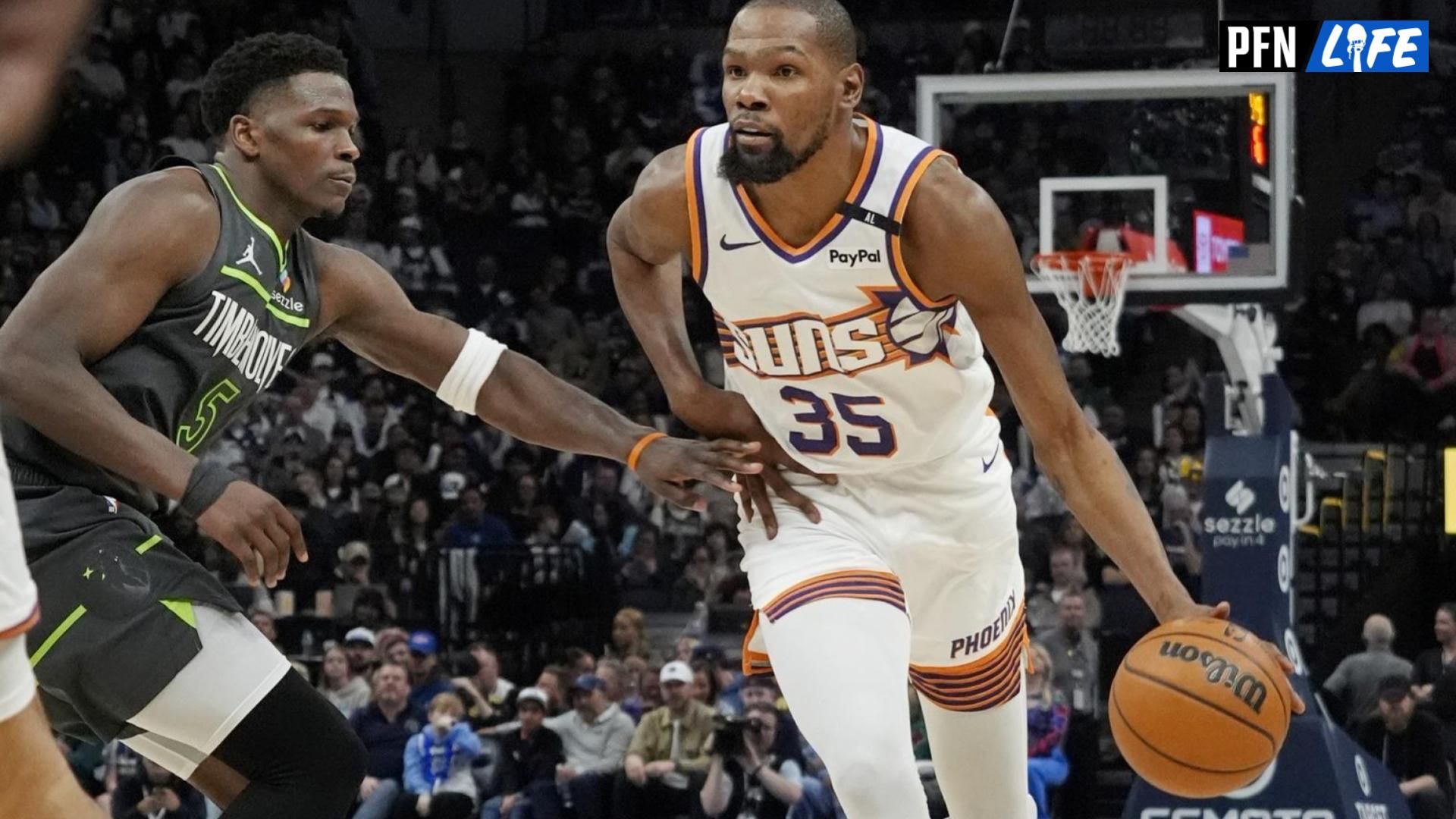 Phoenix Suns forward Kevin Durant (35) brings the ball up as Minnesota Timberwolves guard Anthony Edwards (5) defends him in the fourth quarter at Target Center.