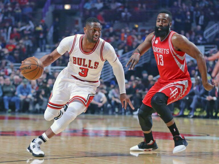 Chicago Bulls guard Dwyane Wade (3) drives around Houston Rockets guard James Harden (13) during the first quarter at the United Center.