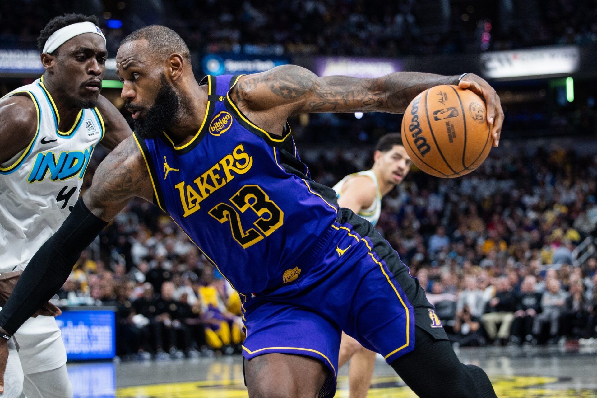 Los Angeles Lakers forward LeBron James (23) dribbles the ball while Indiana Pacers forward Pascal Siakam (43) defends in the second half at Gainbridge Fieldhouse.