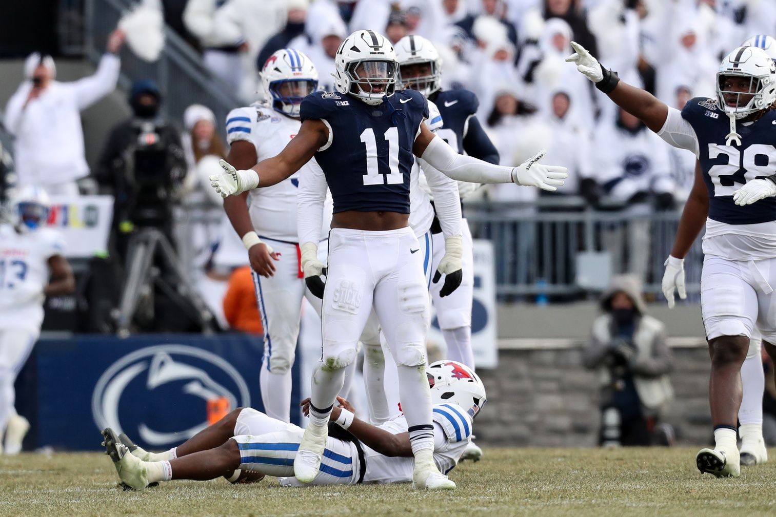 Dec 21, 2024; University Park, Pennsylvania, USA; Penn State Nittany Lions defensive end Abdul Carter (11) reacts after sacking Southern Methodist Mustangs quarterback Kevin Jennings (7) during the third quarter in the first round of the College Football Playoff at Beaver Stadium. Mandatory Credit: Matthew O'Haren-Imagn Images
