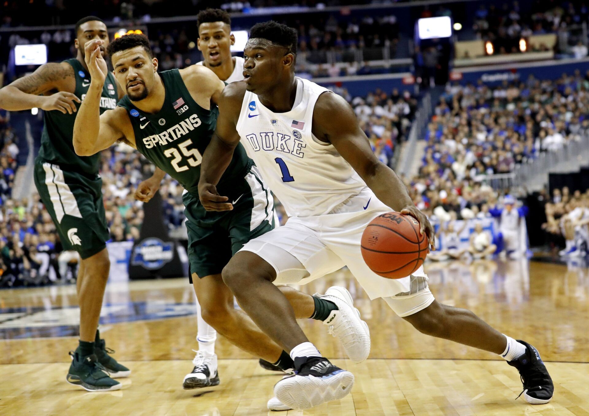 Duke Blue Devils forward Zion Williamson (1) drives to the basket against Michigan State Spartans forward Kenny Goins (25) during the first half in the championship game of the east regional of the 2019 NCAA Tournament at Capital One Arena.