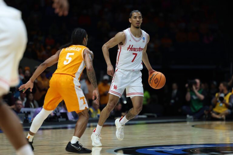 Houston Cougars guard Milos Uzan (7) dribbles the ball against Tennessee Volunteers guard Zakai Zeigler (5) in the first half during the Midwest Regional final of the 2025 NCAA tournament at Lucas Oil Stadium.