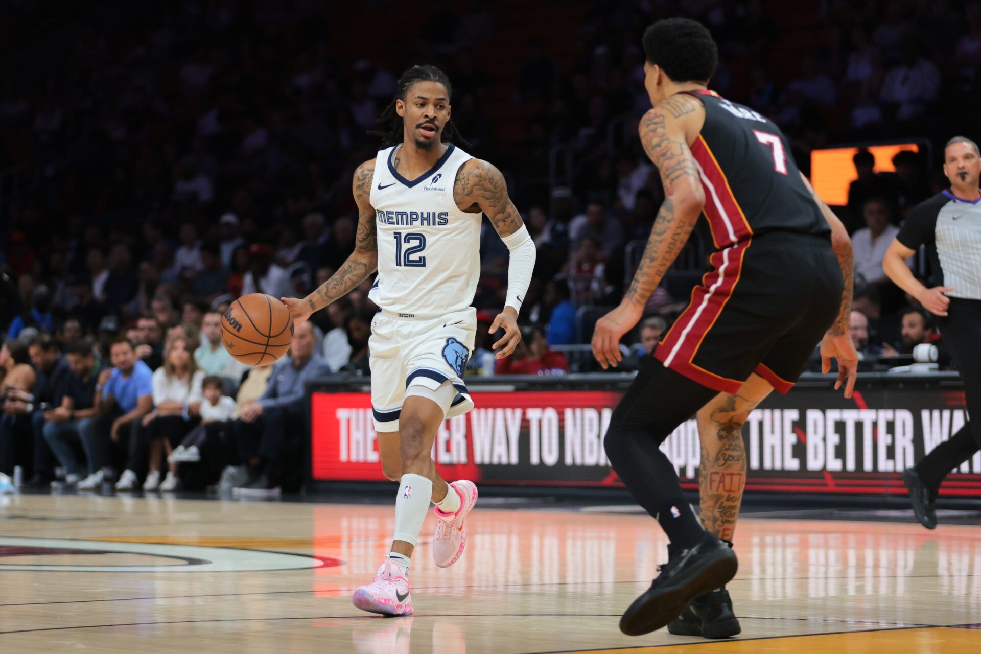 Memphis Grizzlies guard Ja Morant (12) dribbles the basketball as Miami Heat center Kel'el Ware (7) defends during the first quarter at Kaseya Center.