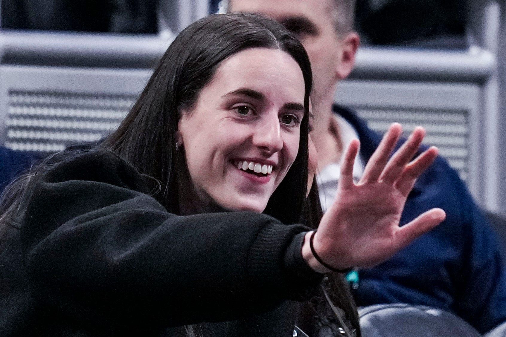 Indiana Fever guard Caitlin Clark (22) waves to her former teammates Wednesday, March 5, 2025, in a round one game at the 2025 TIAA Big Ten Women's Basketball Tournament between the Iowa Hawkeyes and the Wisconsin Badgers at Gainbridge Fieldhouse in Indianapolis.