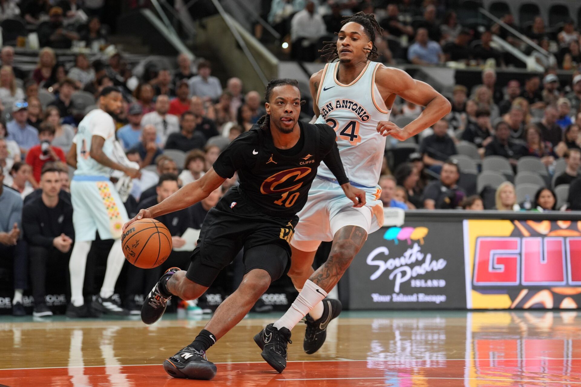 Cleveland Cavaliers guard Darius Garland (10) drives past San Antonio Spurs guard Devin Vassell (24) in the first half at Frost Bank Center.