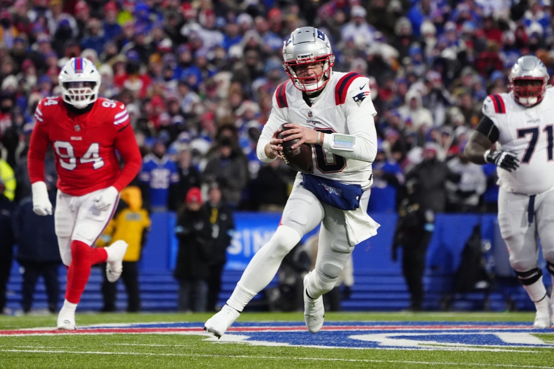 New England Patriots quarterack Drake Maye (10) runs with the ball against the Buffalo Bills during the first half at Highmark Stadium.
