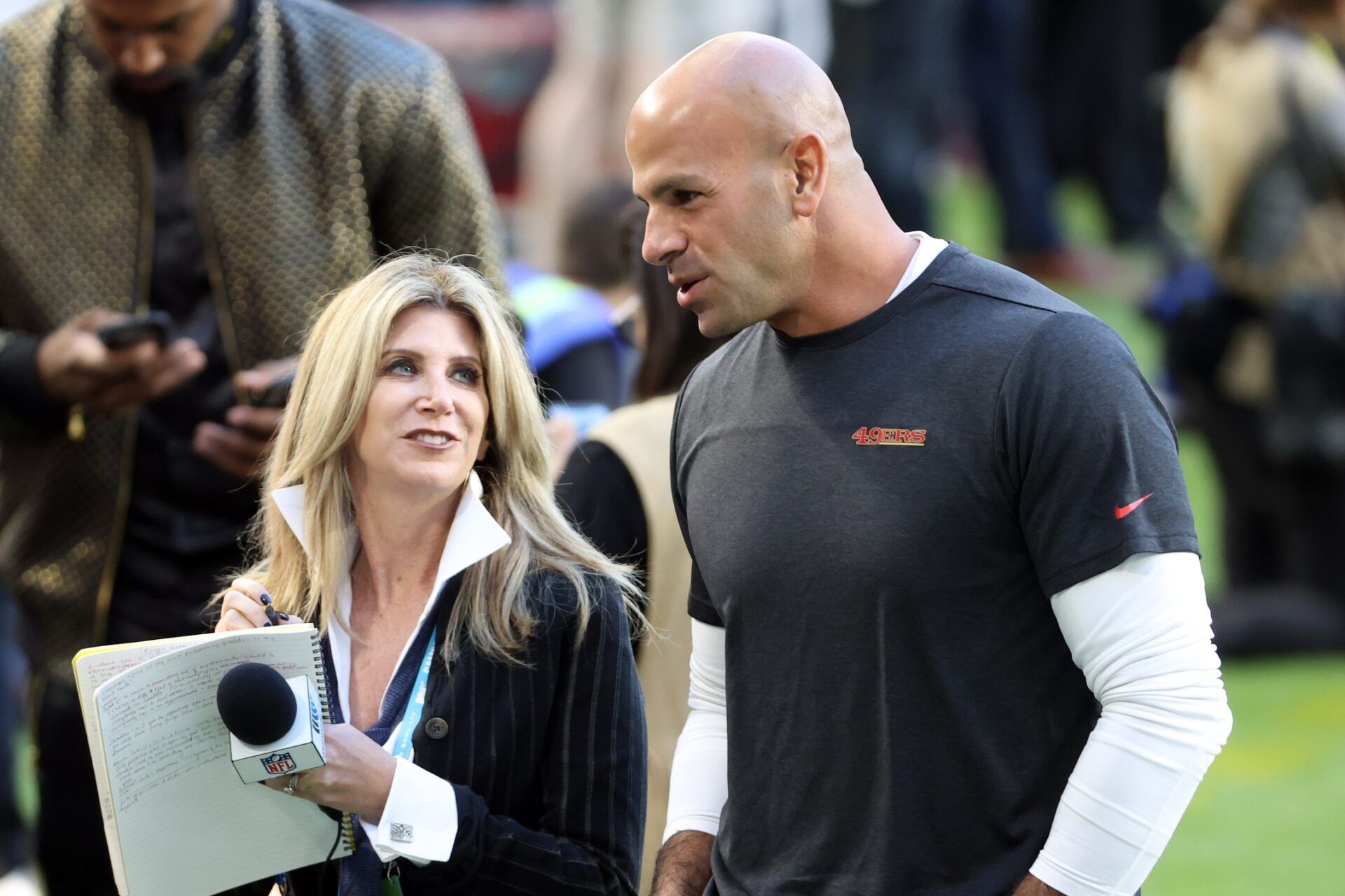 San Francisco 49ers defensive coordinator Robert Saleh (right) talks to Westwood one Laura Okmin (left) on the field prior to Super Bowl LIV against the Kansas City Chiefs at Hard Rock Stadium.