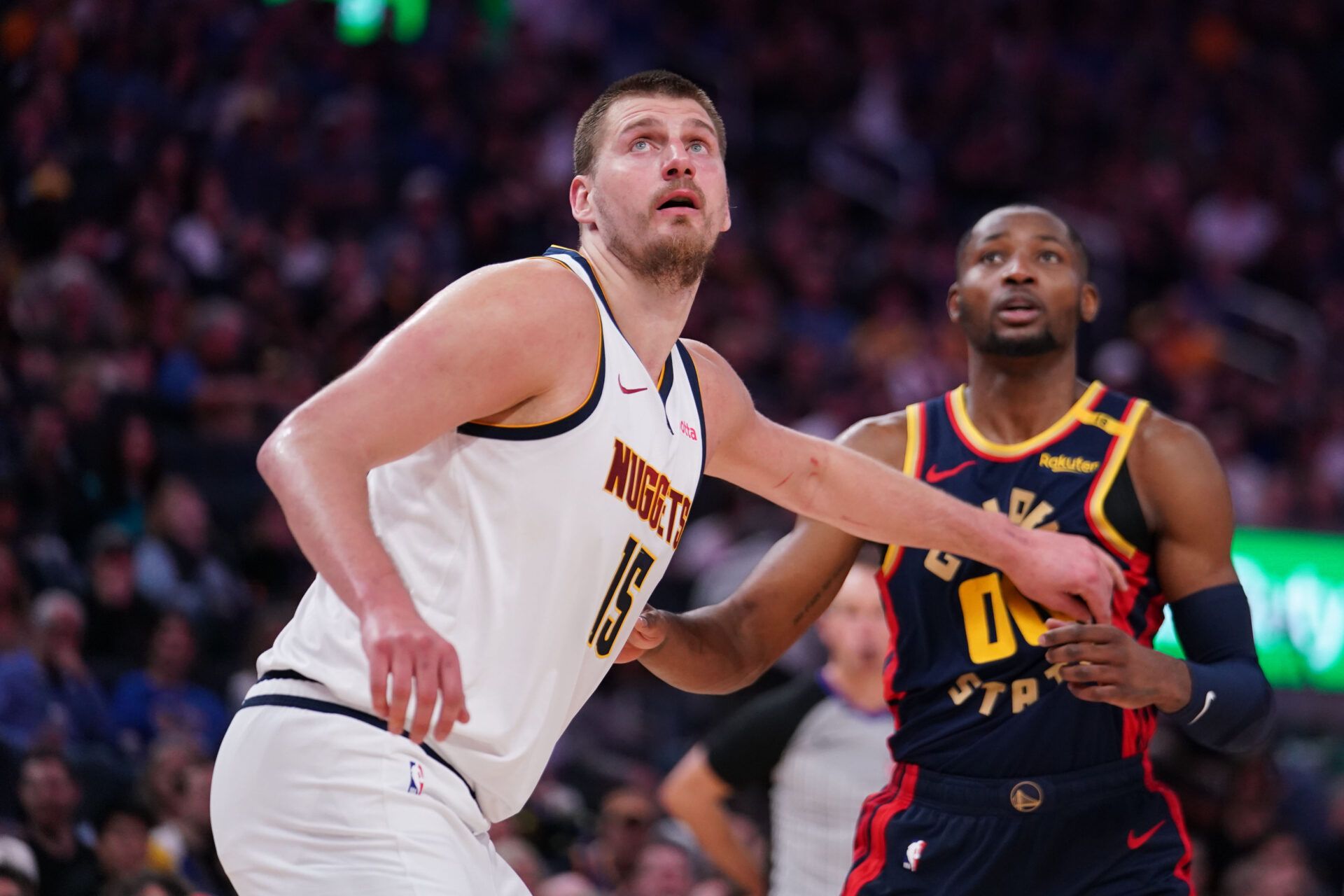 Apr 4, 2025; San Francisco, California, USA; Denver Nuggets center Nikola Jokic (15) boxes out Golden State Warriors forward Jonathan Kuminga (00) in the third period at Chase Center. Mandatory Credit: David Gonzales-Imagn Images
