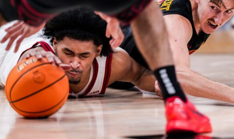 Rutgers Scarlet Knights guard Dylan Harper (2) and USC Trojans guard Clark Slajchert (32) fight for the ball Wednesday, March 12, 2025, in a first round game at the 2025 TIAA Big Ten Men’s Basketball Tournament between the USC Trojans and the Rutgers Scarlet Knights at Gainbridge Fieldhouse in Indianapolis. The Hawkeyes defeated the Buckeyes, 77-70.