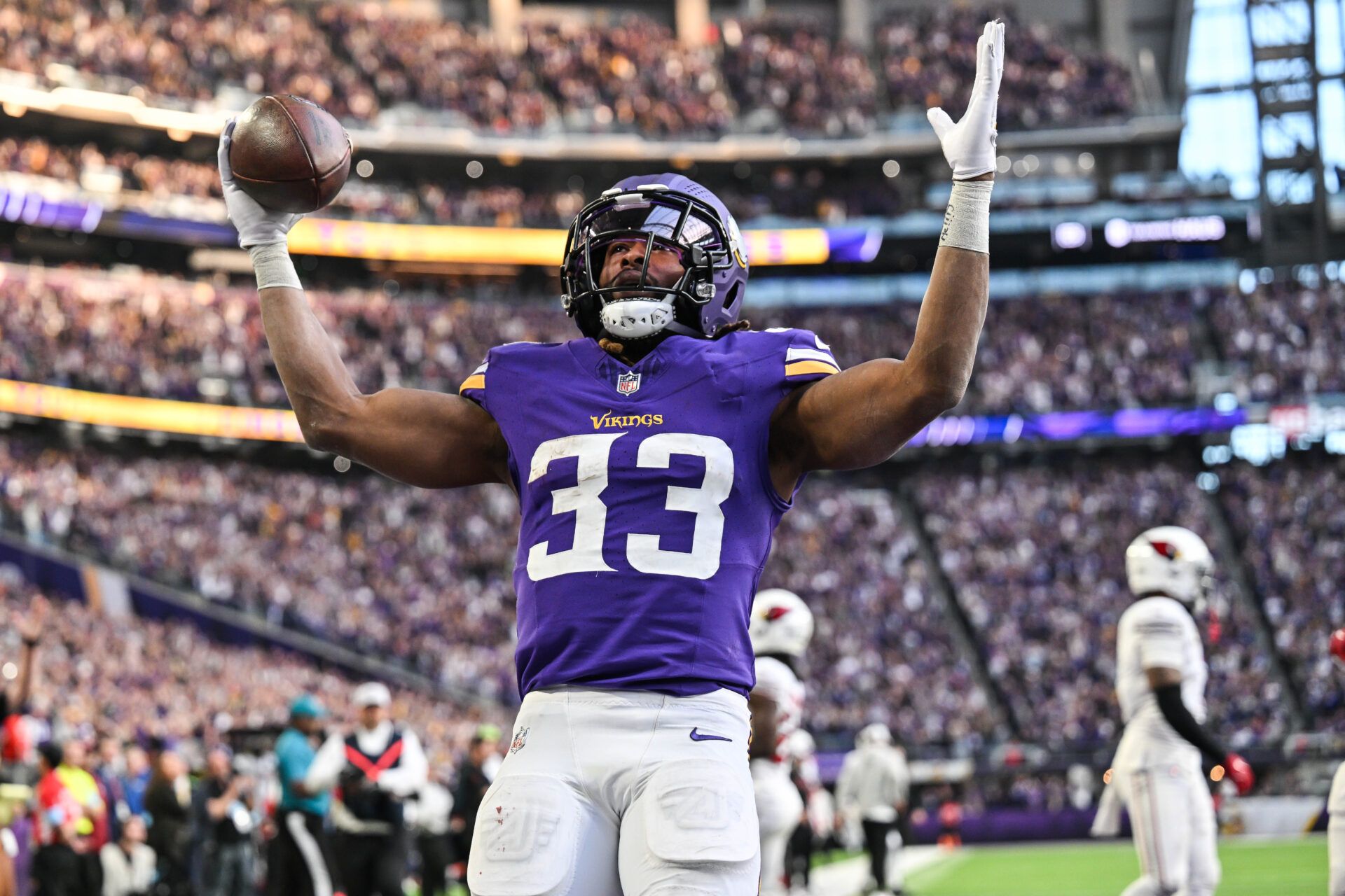 Dec 1, 2024; Minneapolis, Minnesota, USA; Minnesota Vikings running back Aaron Jones (33) reacts after scoring the game winning touchdown against the Arizona Cardinals during the fourth quarter at U.S. Bank Stadium. Mandatory Credit: Jeffrey Becker-Imagn Images