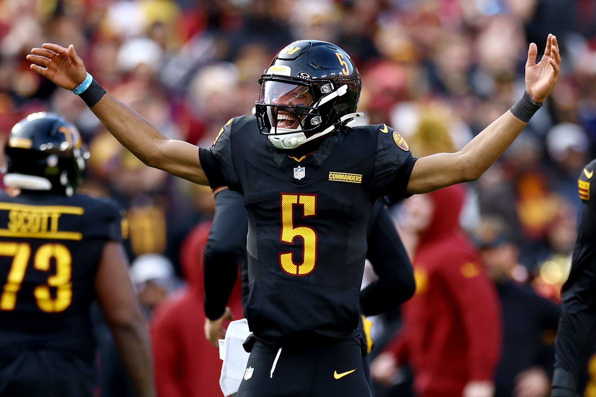 LANDOVER, MARYLAND - DECEMBER 01: Jayden Daniels #5 of the Washington Commanders celebrates after a touchdown in the first quarter of a game against the Tennessee Titansat Northwest Stadium on December 01, 2024 in Landover, Maryland. (Photo by Tim Nwachukwu/Getty Images)