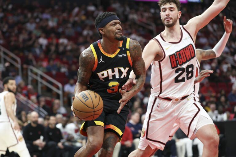 Phoenix Suns guard Bradley Beal (3) controls the ball as Houston Rockets center Alperen Sengun (28) defends during the second quarter at Toyota Center.