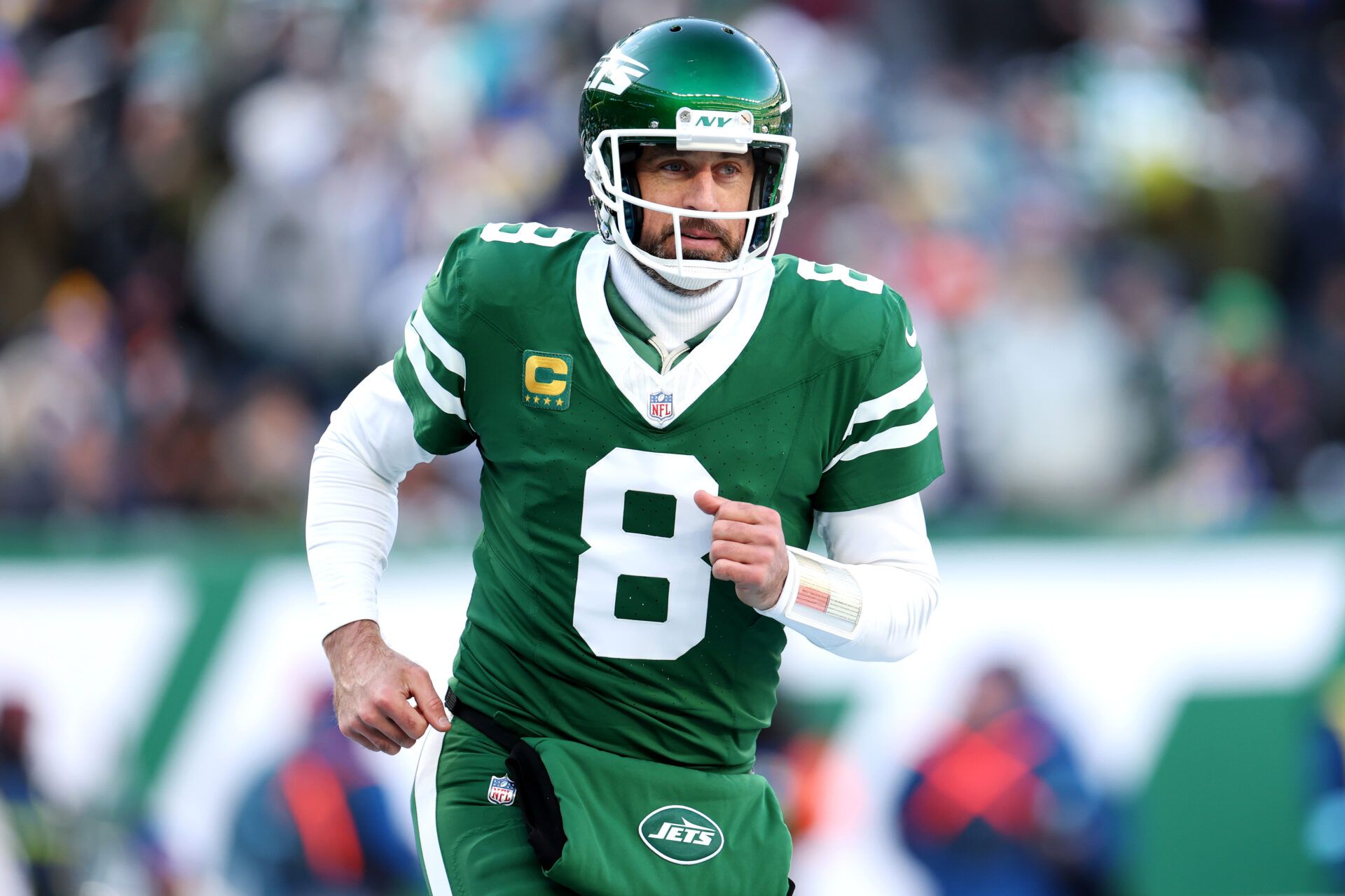 EAST RUTHERFORD, NEW JERSEY - DECEMBER 22: Aaron Rodgers #8 of the New York Jets runs off the field during a game against the Los Angeles Rams at MetLife Stadium on December 22, 2024 in East Rutherford, New Jersey. (Photo by Emilee Chinn/Getty Images)