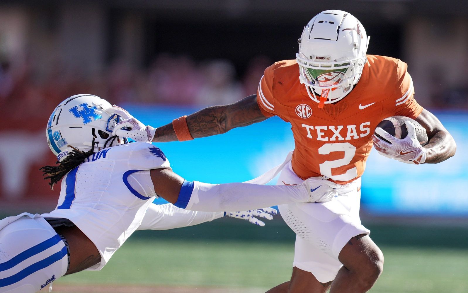 Texas Longhorns wide receiver Matthew Golden (2) stiff arms Kentucky Wildcats defensive back Maxwell Hairston (1) in the first quarter of an NCAA college football game at Darrell K Royal Texas Memorial Stadium in Austin, Texas on Saturday, Nov. 24, 2024.