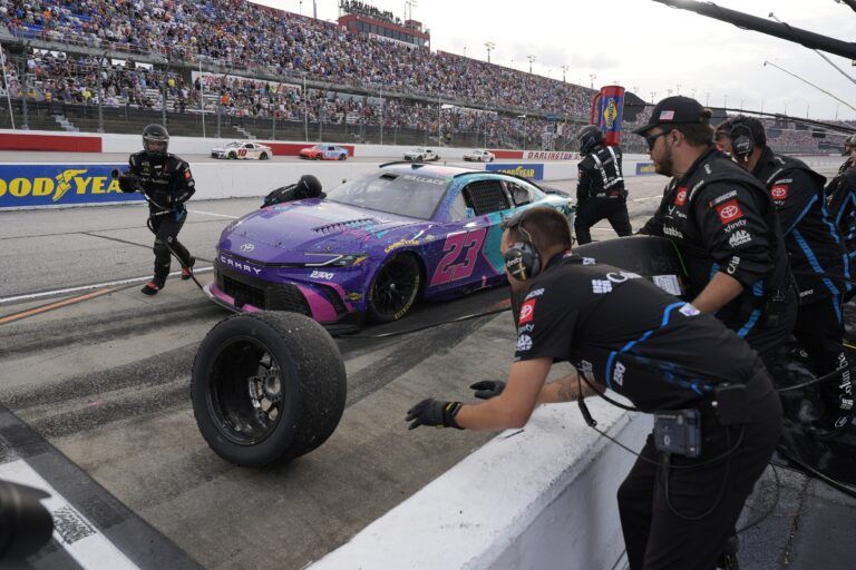 NASCAR Cup Series driver Bubba Wallace (23) pit crew goes to work late in the race during the Goodyear 400 at Darlington Raceway.