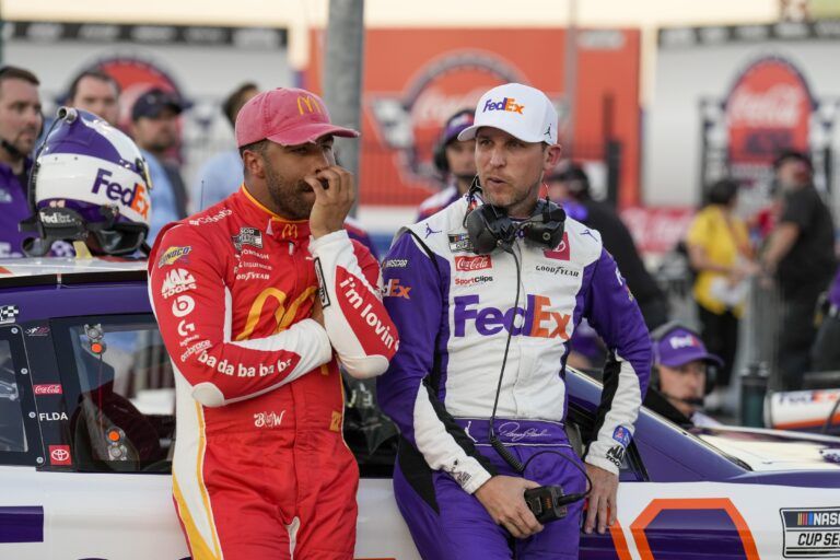 NASCAR Cup Series driver Bubba Wallace (23) and driver Denny Hamlin (11) talk during Nascar Cup qualifying at Charlotte Motor Speedway.