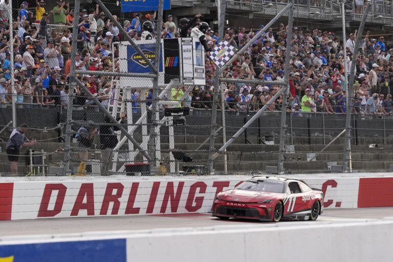 NASCAR Cup Series driver Denny Hamlin (11) takes the checkered flag for the win during the Goodyear 400 at Darlington Raceway.