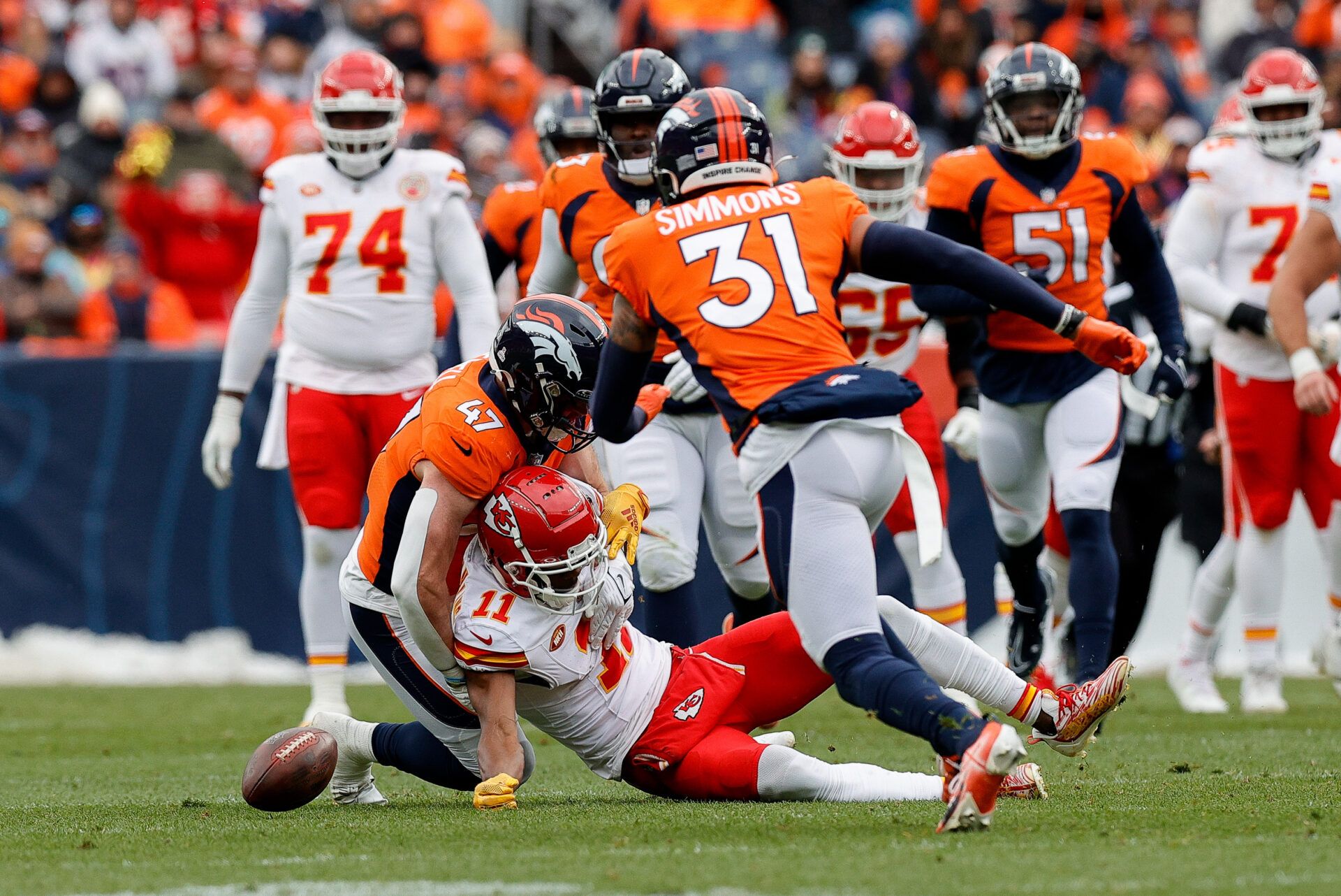 Oct 29, 2023; Denver, Colorado, USA; Kansas City Chiefs wide receiver Marquez Valdes-Scantling (11) fumbles the ball against Denver Broncos linebacker Josey Jewell (47) as safety Justin Simmons (31) runs to pick up the ball in the second quarter at Empower Field at Mile High. Mandatory Credit: Isaiah J. Downing-USA TODAY Sports