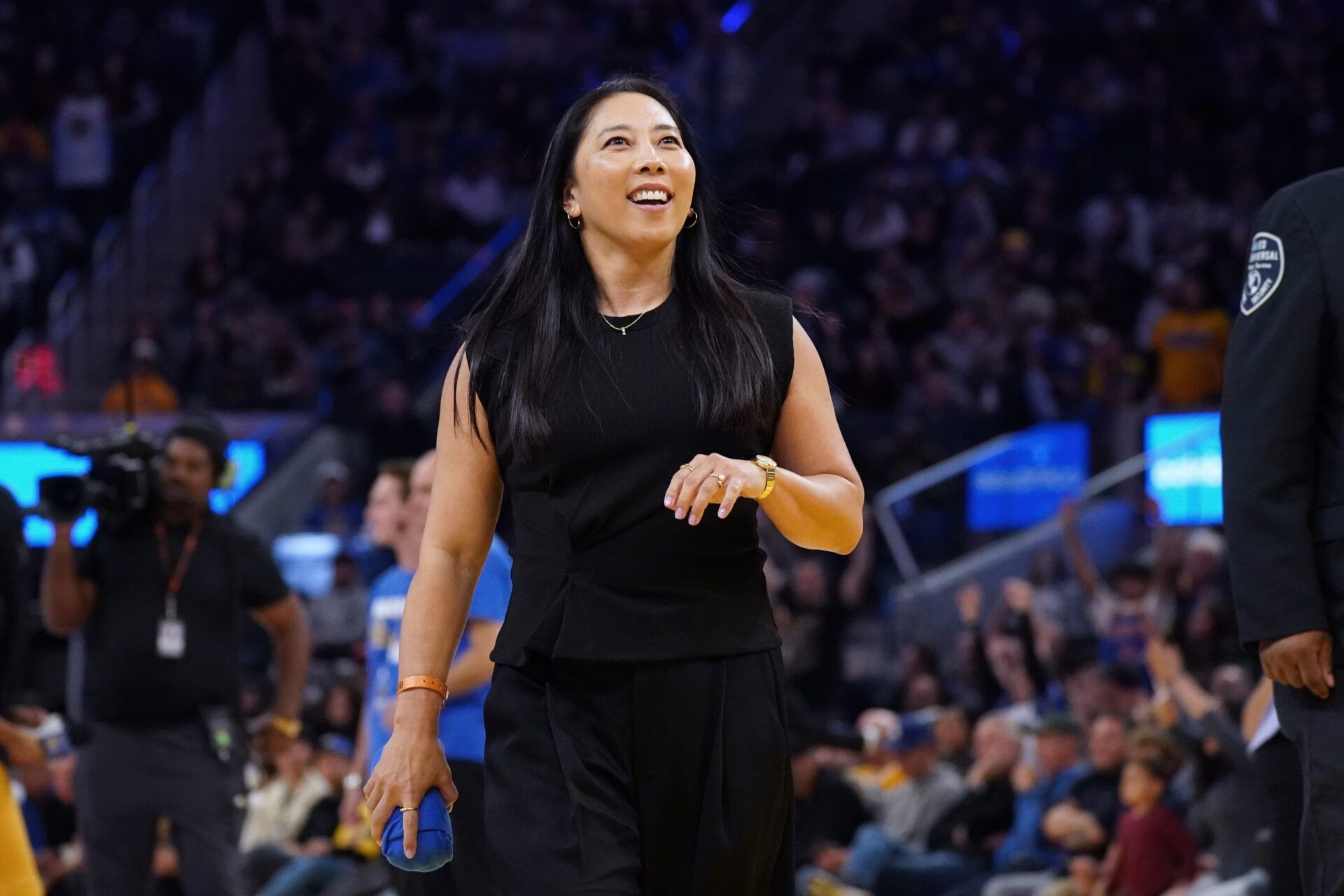 Valkyries head coach Natalie Nakase throws t-shirts into the stands in the fourth quarter during a Golden State Warriors game against the New Orleans Pelicans at Chase Center.