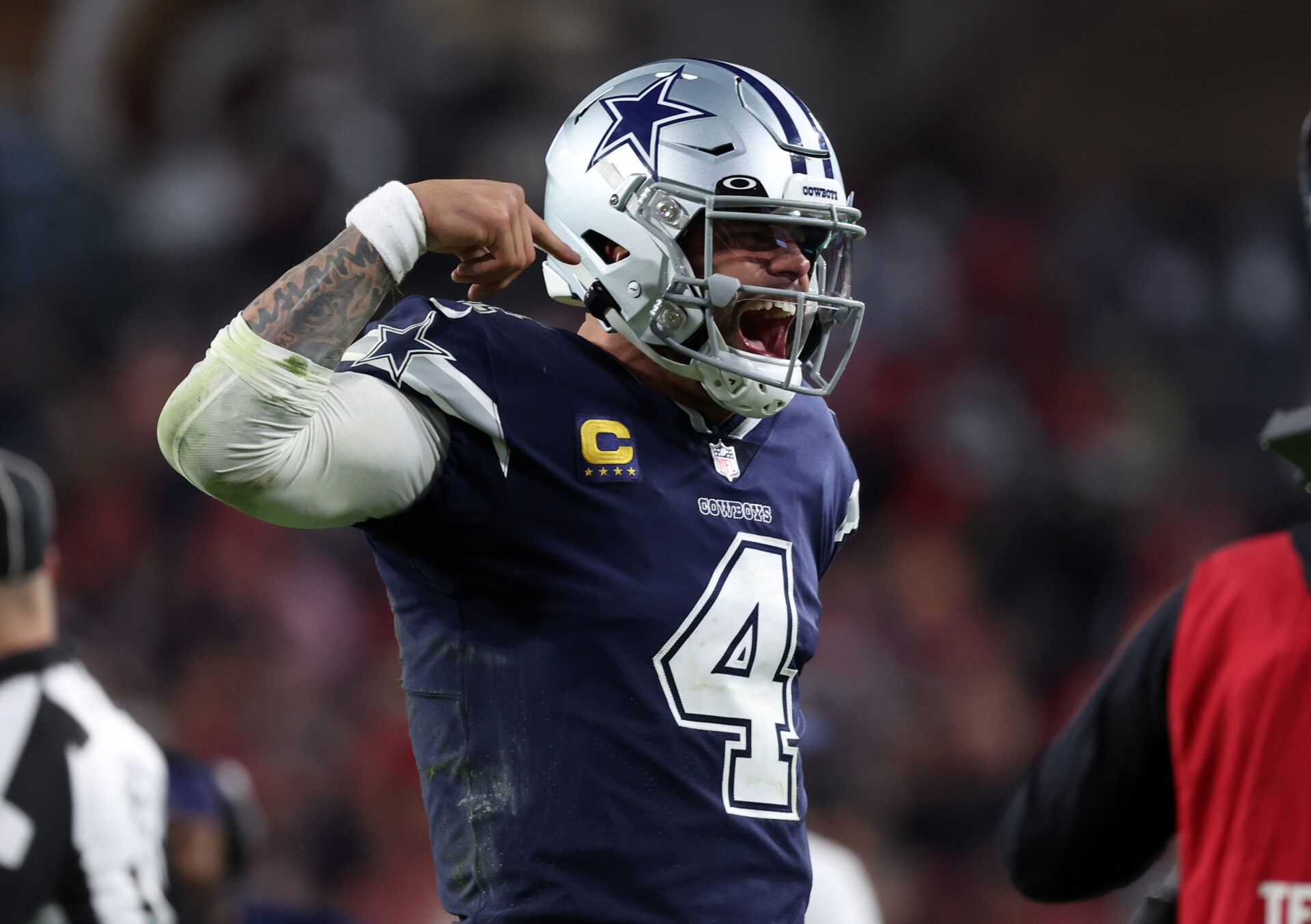 Jan 16, 2023; Tampa, Florida, USA; Dallas Cowboys quarterback Dak Prescott (4) reacts after throwing a touchdown pass against the Tampa Bay Buccaneers in the second half during the wild card game at Raymond James Stadium. Mandatory Credit: Kim Klement-USA TODAY Sports