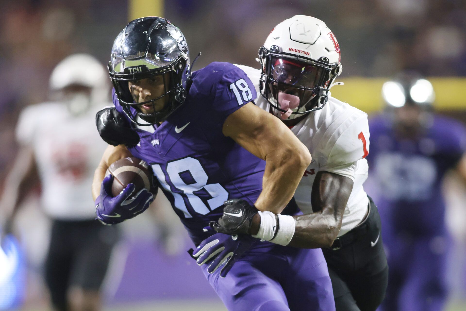 Oct 4, 2024; Fort Worth, Texas, USA; TCU Horned Frogs wide receiver Jack Bech (18) breaks the tackle of Houston Cougars defensive back Latrell McCutchin Sr. (1) and scores a touchdown in the fourth quarter at Amon G. Carter Stadium. Mandatory Credit: Tim Heitman-Imagn Images