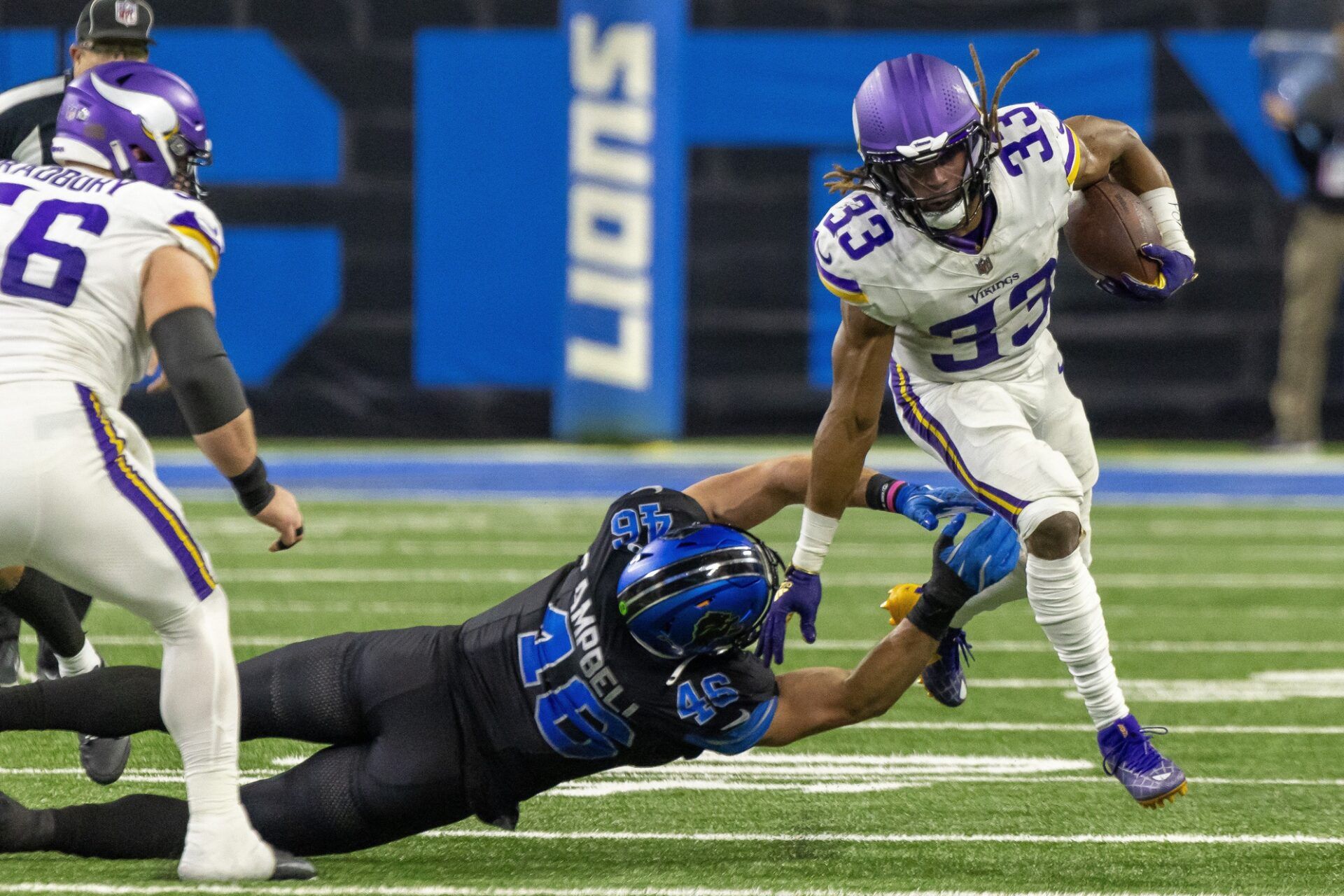 Minnesota Vikings running back Aaron Jones (33) avoids a tackle from Detroit Lions linebacker Jack Campbell (46) during the second half at Ford Field.