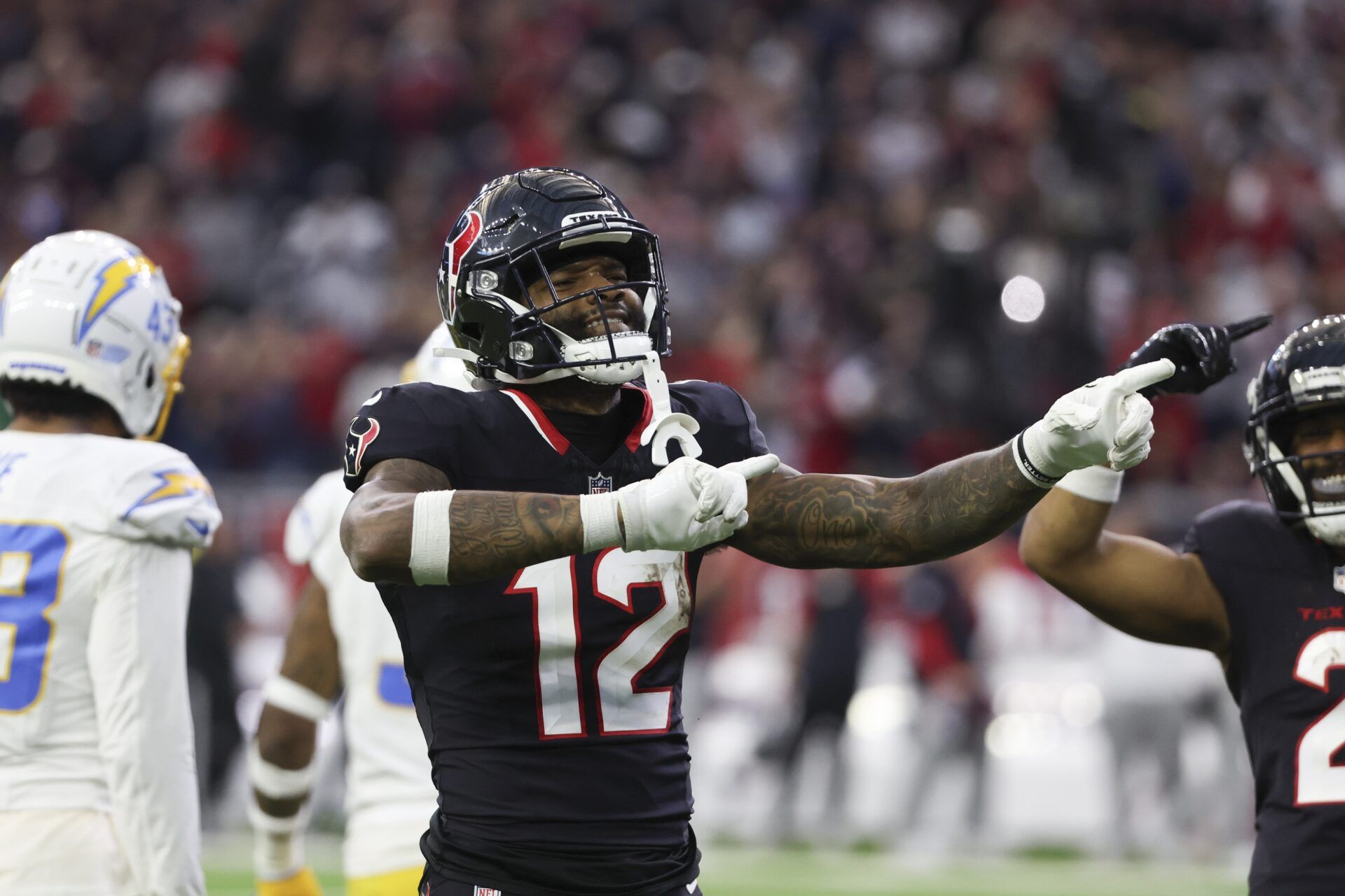 Houston Texans wide receiver Nico Collins (12) reacts to a first down against the Los Angeles Chargers in the second quarter in an AFC wild card game at NRG Stadium.