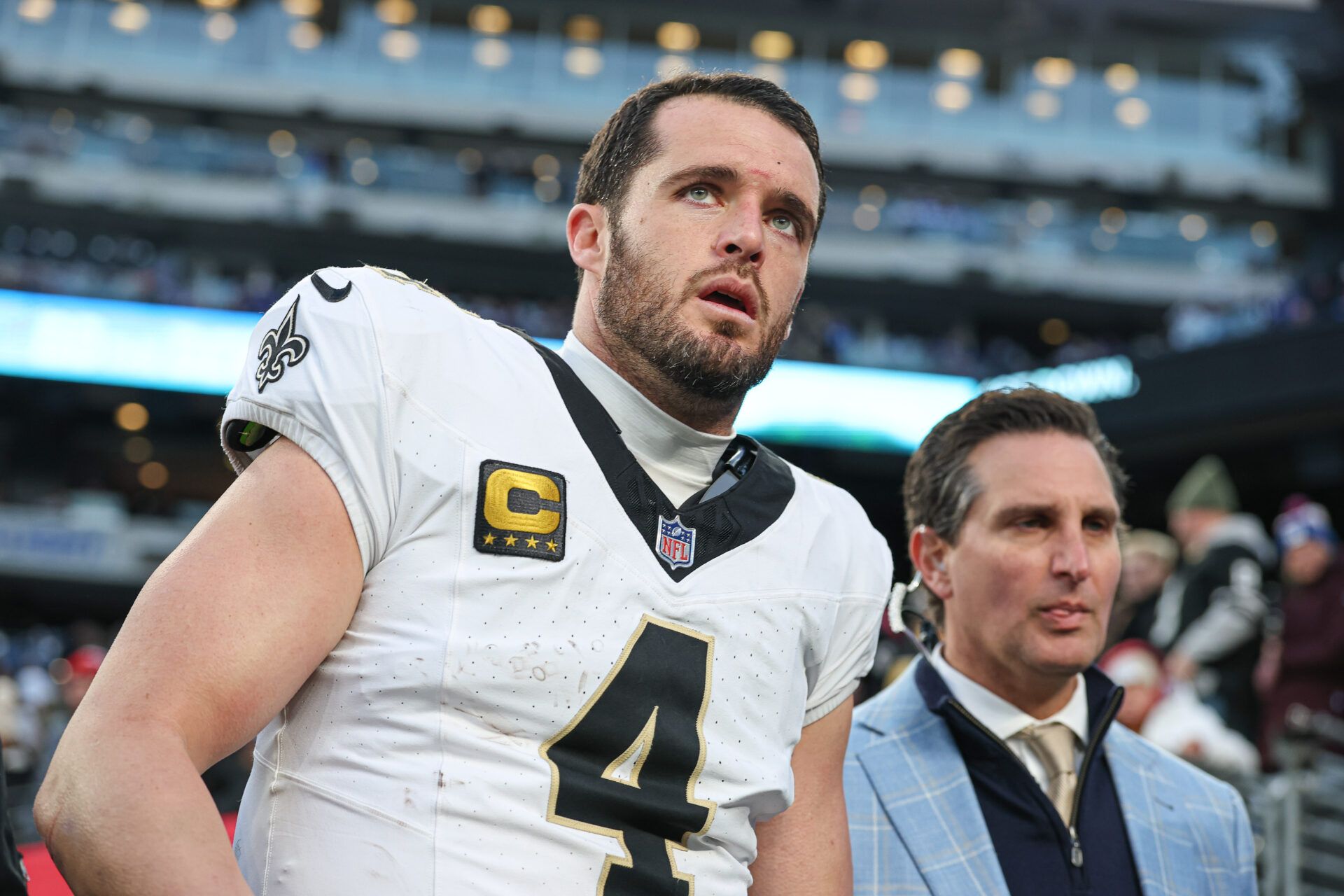 Dec 8, 2024; East Rutherford, New Jersey, USA; New Orleans Saints quarterback Derek Carr (4) walks off the field after field after an injury during the fourth quarter at MetLife Stadium. Mandatory Credit: Vincent Carchietta-Imagn Images