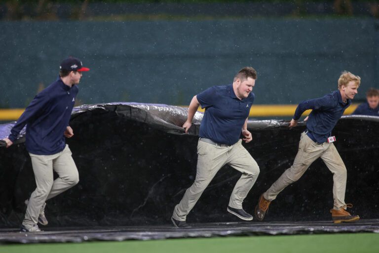 What are the MLB’s rain delay rules, when does a game becomes official, and what happens if weather forces a suspension before nine innings?