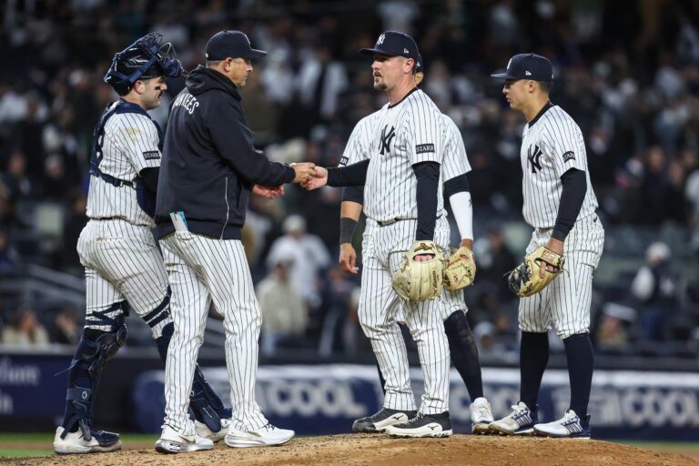 New York Yankees relief pitcher Mark Leiter Jr. (56) is taken out of the game by manager Aaron Boone (17) in the eighth inning against the Arizona Diamondbacks at Yankee Stadium.