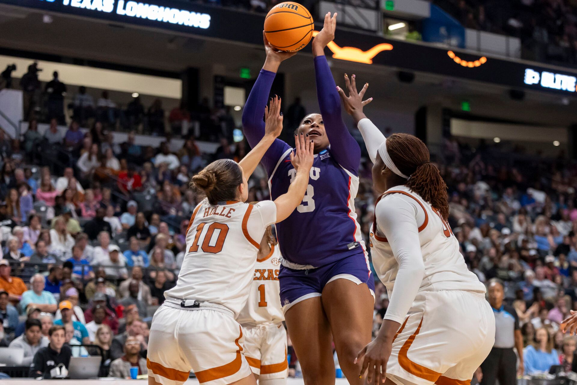 Mar 31, 2025; Birmingham, AL, USA; TCU Horned Frogs forward Deasia Merrill (3) rebounds the ball and shoots and scores over Texas Longhorns guard Shay Holle (10) during the second half of an Elite 8 NCAA Tournament basketball game at Legacy Arena. Mandatory Credit: Vasha Hunt-Imagn Images