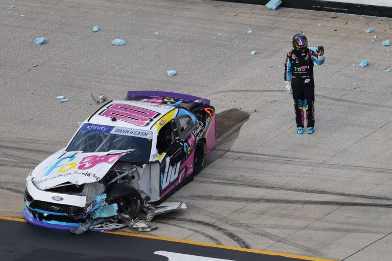 Apr 12, 2025; Bristol, Tennessee, USA; NASCAR Xfinity Series driver Sheldon Creed (00) exits his car after crashing during the NASCAR SciAps 300 at Bristol Motor Speedway. Mandatory Credit: Randy Sartin-Imagn Images