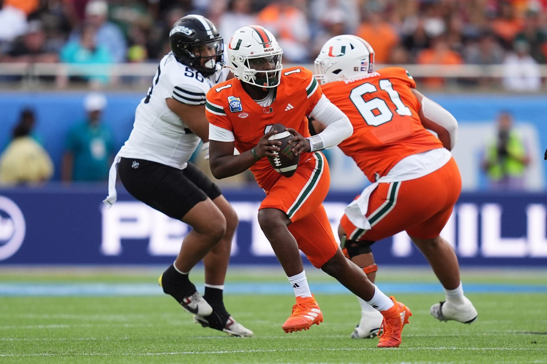 Dec 28, 2024; Orlando, FL, USA; Miami Hurricanes quarterback Cam Ward (1) scrambles with the ball against the Iowa State Cyclones during the first half at Camping World Stadium. Mandatory Credit: Jasen Vinlove-Imagn Images