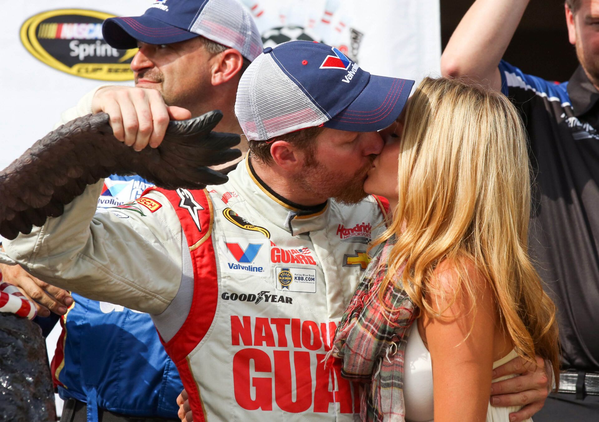 Aug 3, 2014; Long Pond, PA, USA; NASCAR Sprint Cup Series driver Dale Earnhardt Jr. (88) kisses his girlfriend Amy Reimann on victory lane after winning the GoBowling.com 400 at Pocono Raceway. Mandatory Credit: Bill Streicher-USA TODAY Sports
