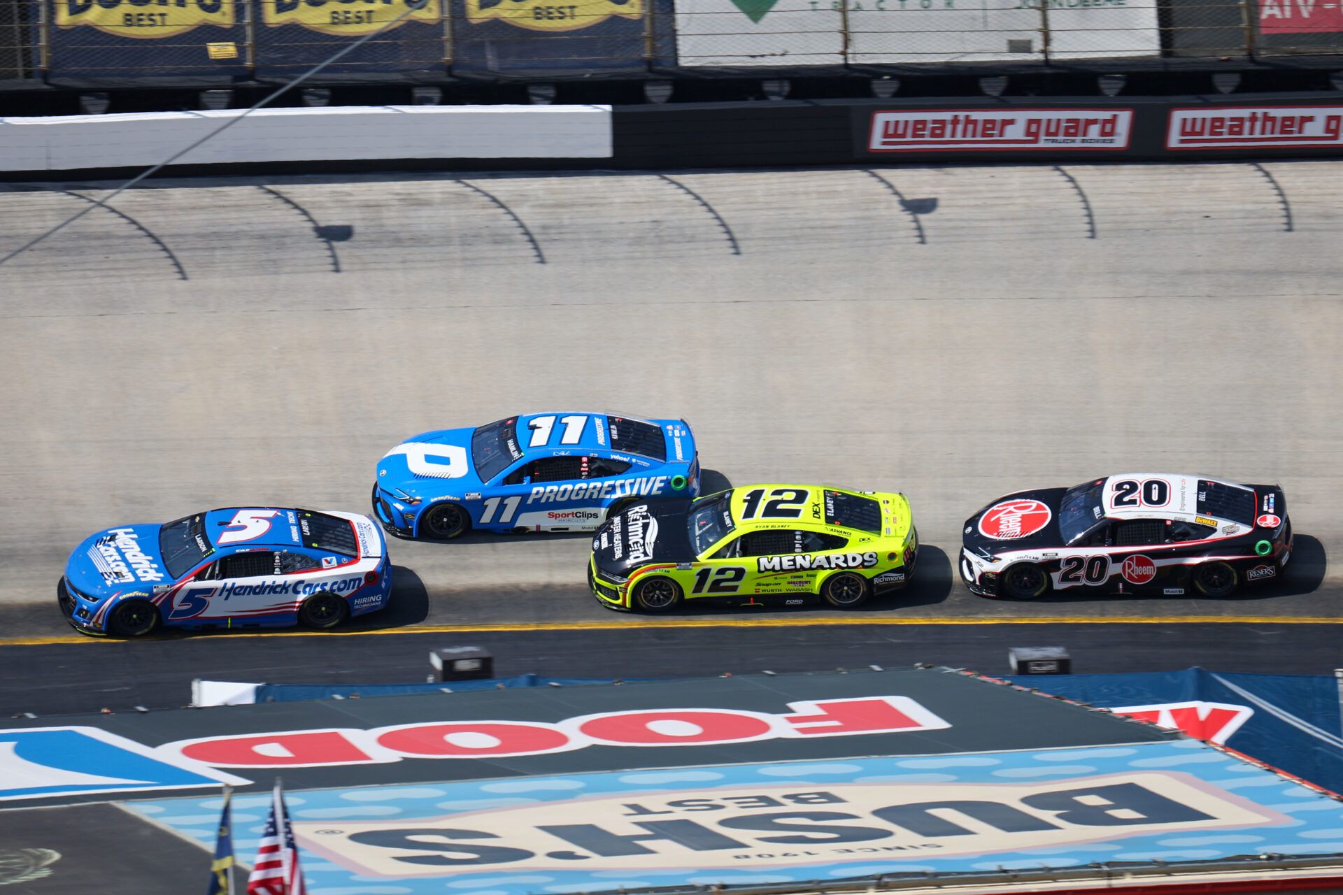 Apr 13, 2025; Bristol, Tennessee, USA; NASCAR Cup Series driver Kyle Larson (5) leads driver Denny Hamlin (11) during the NASCAR Food City 500 at Bristol Motor Speedway. Mandatory Credit: Randy Sartin-Imagn Images