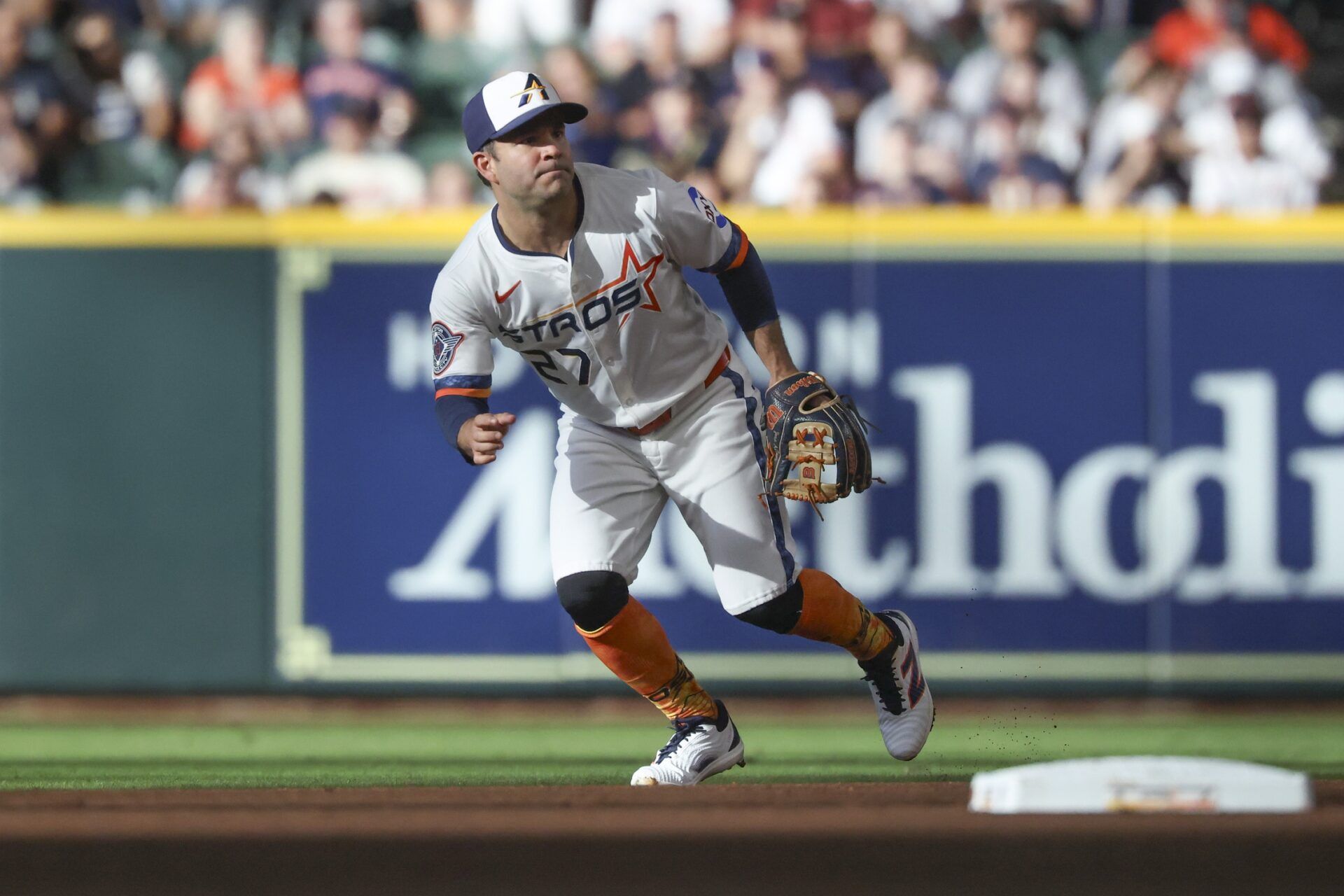 Houston Astros second baseman Jose Altuve (27) attempts to field a ball during the first inning against the Los Angeles Angels at Daikin Park.