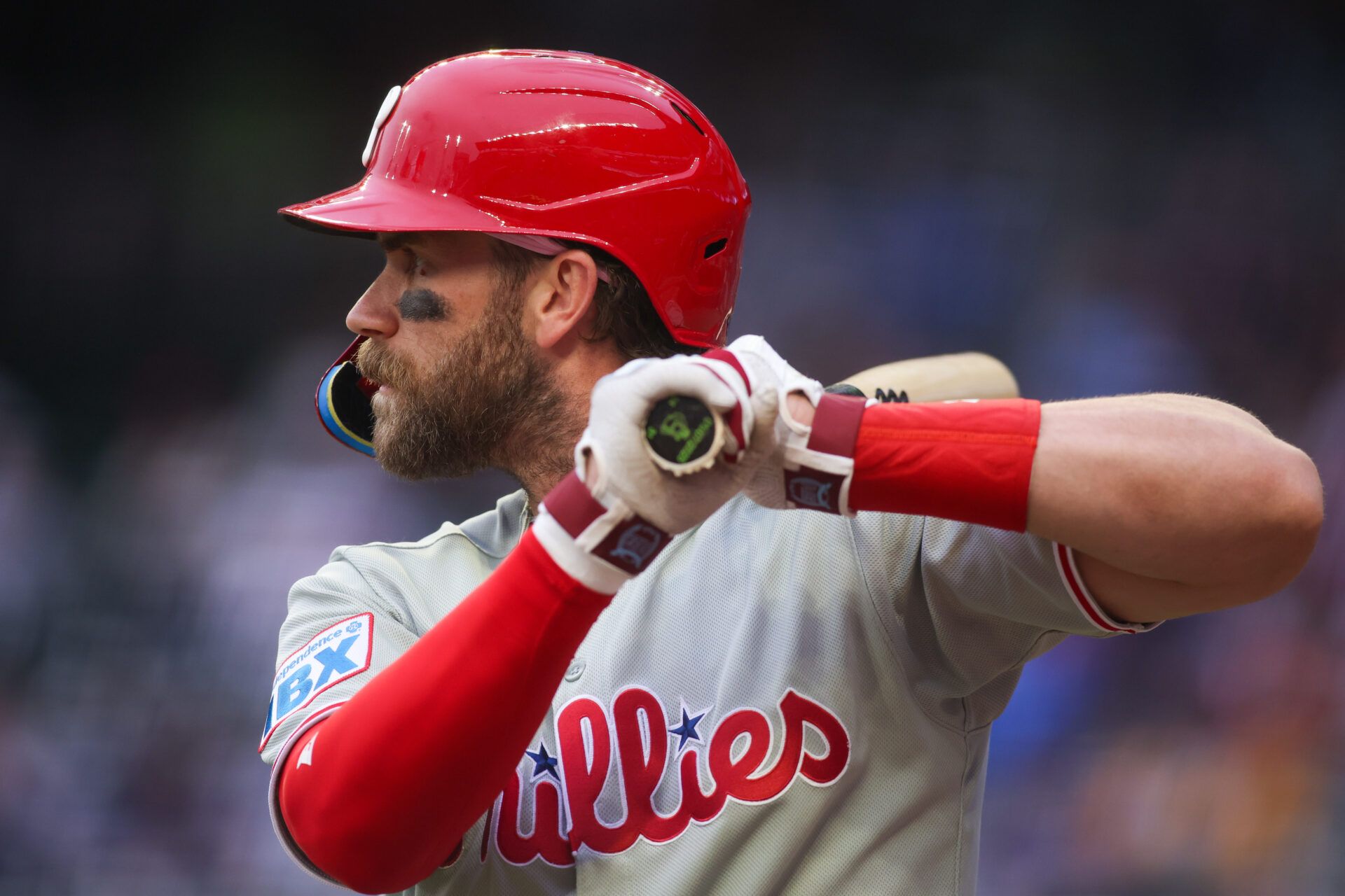 Bryce Harper revealed his fourth child’s gender during a Phillies game using a bat, and Trea Turner playfully teased him with the wrong one first.