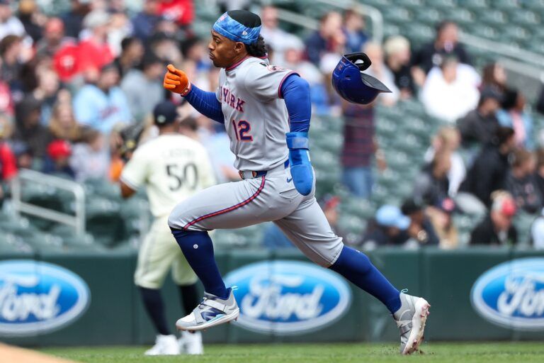New York Mets shortstop Francisco Lindor (12) runs towards third base on a double hit by first baseman Pete Alonso (20) during the eighth inning against the Minnesota Twins at Target Field.