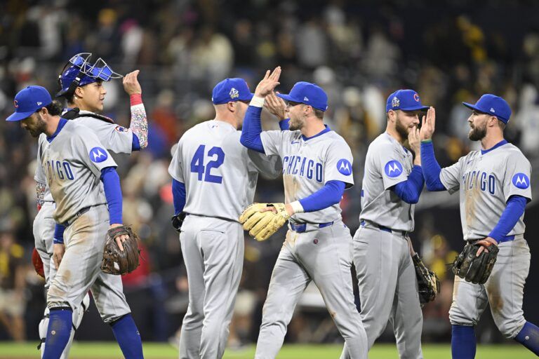 Chicago Cubs players high-five after the Cubs beat the San Diego Padres 2-1 at Petco Park.