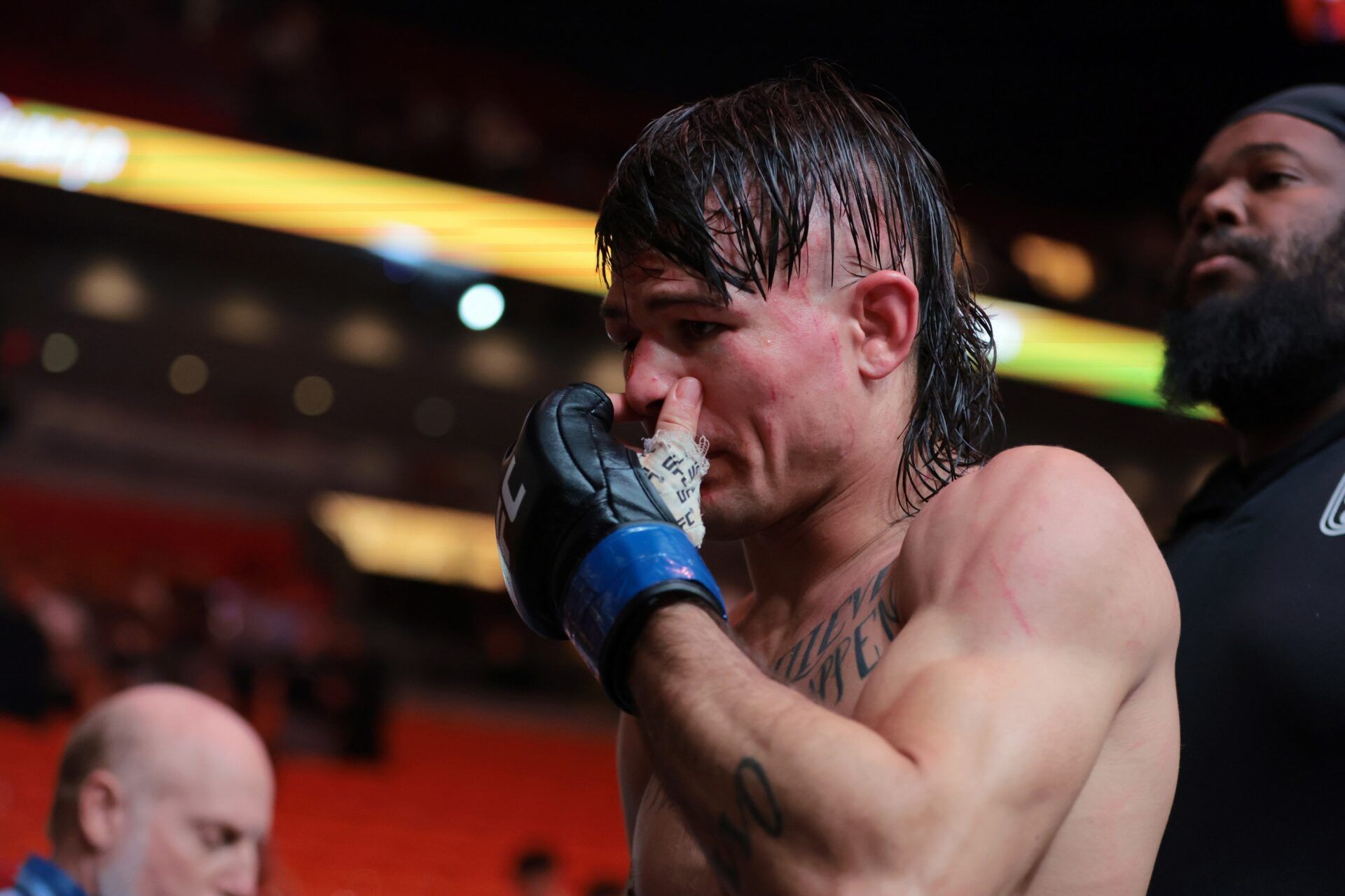 Diego Lopes (blue gloves) reacts after losing to Alexander Volkanovski (not pictured) during UFC 314 at Kaseya Center.