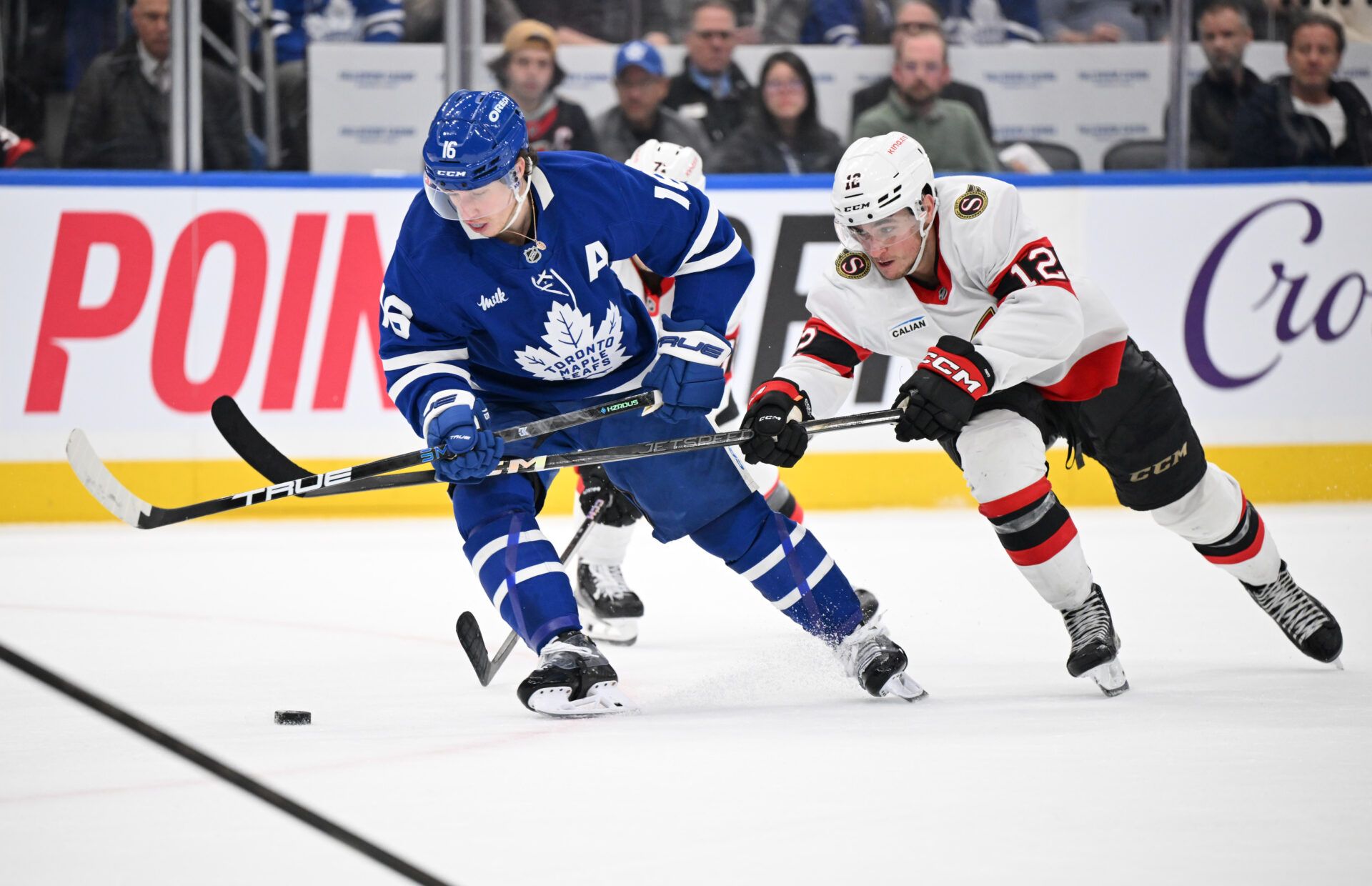 Toronto Maple Leafs forward Mitch Marner (16) has his stick lifted by Ottawa Senators forward Shane Pinto (12) in the third period at Scotiabank Arena.