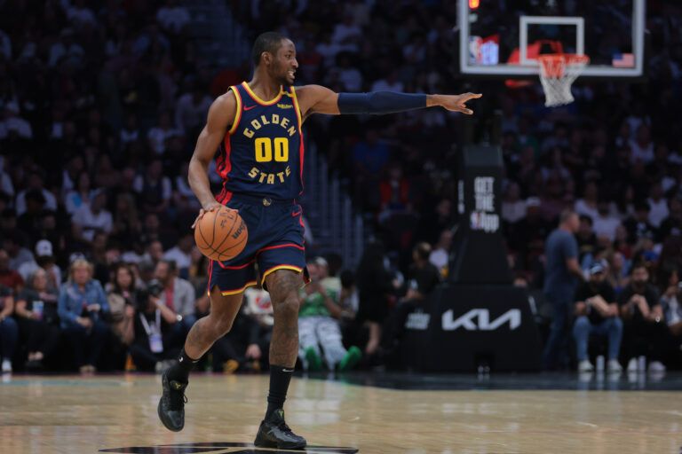 Mar 25, 2025; Miami, Florida, USA; Golden State Warriors forward Jonathan Kuminga (00) signals against the Miami Heat during the first quarter at Kaseya Center. Mandatory Credit: Sam Navarro-Imagn Images