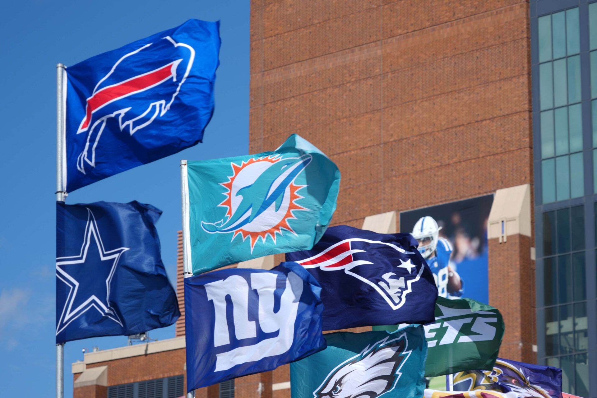 Feb 27, 2025; Indianapolis, IN, USA; Buffalo Bills, Dallas Cowboys, Miami Dolphins, New York Giants, New England Patriots, Philadelphia Eagles and New York Jets flags at the 2025 NFL Scouting Combine Experience at Lucas Oil Stadium. Mandatory Credit: Kirby Lee-Imagn Images