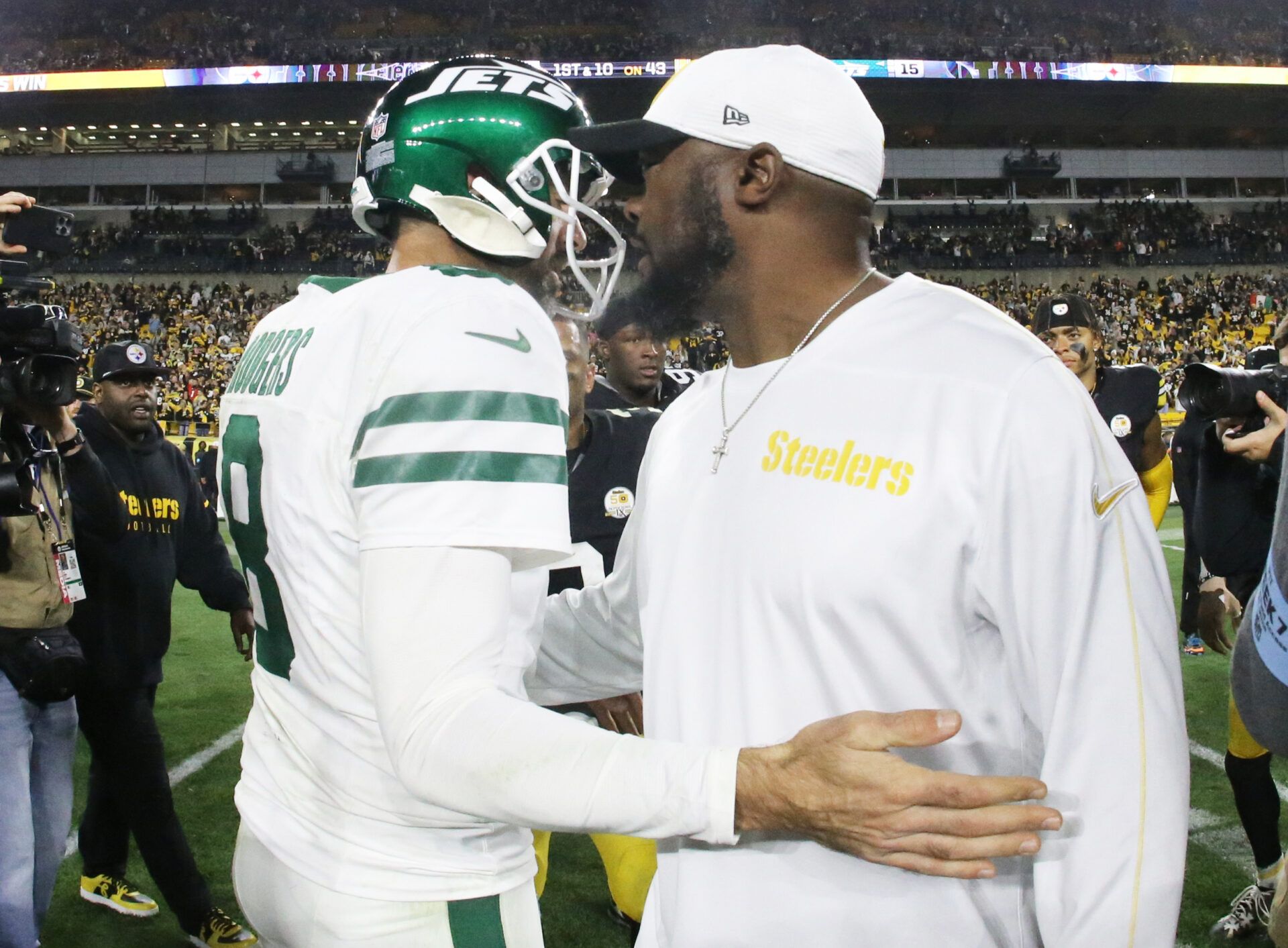 Oct 20, 2024; Pittsburgh, Pennsylvania, USA; New York Jets quarterback Aaron Rodgers (8) and Pittsburgh Steelers head coach Mike Tomlin (right) greet each other after their game at Acrisure Stadium. Mandatory Credit: Charles LeClaire-Imagn Images