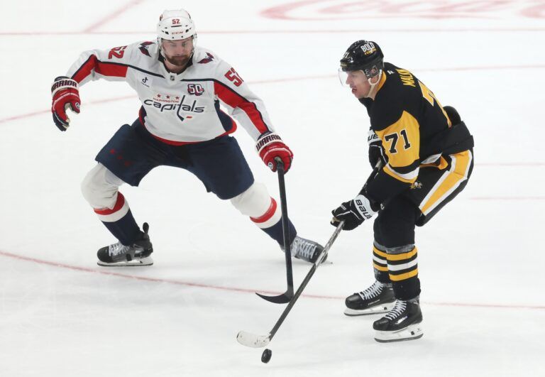 Pittsburgh Penguins center Evgeni Malkin (71) moves the puck against Washington Capitals defenseman Dylan McIlrath (52) during the third period at PPG Paints Arena.