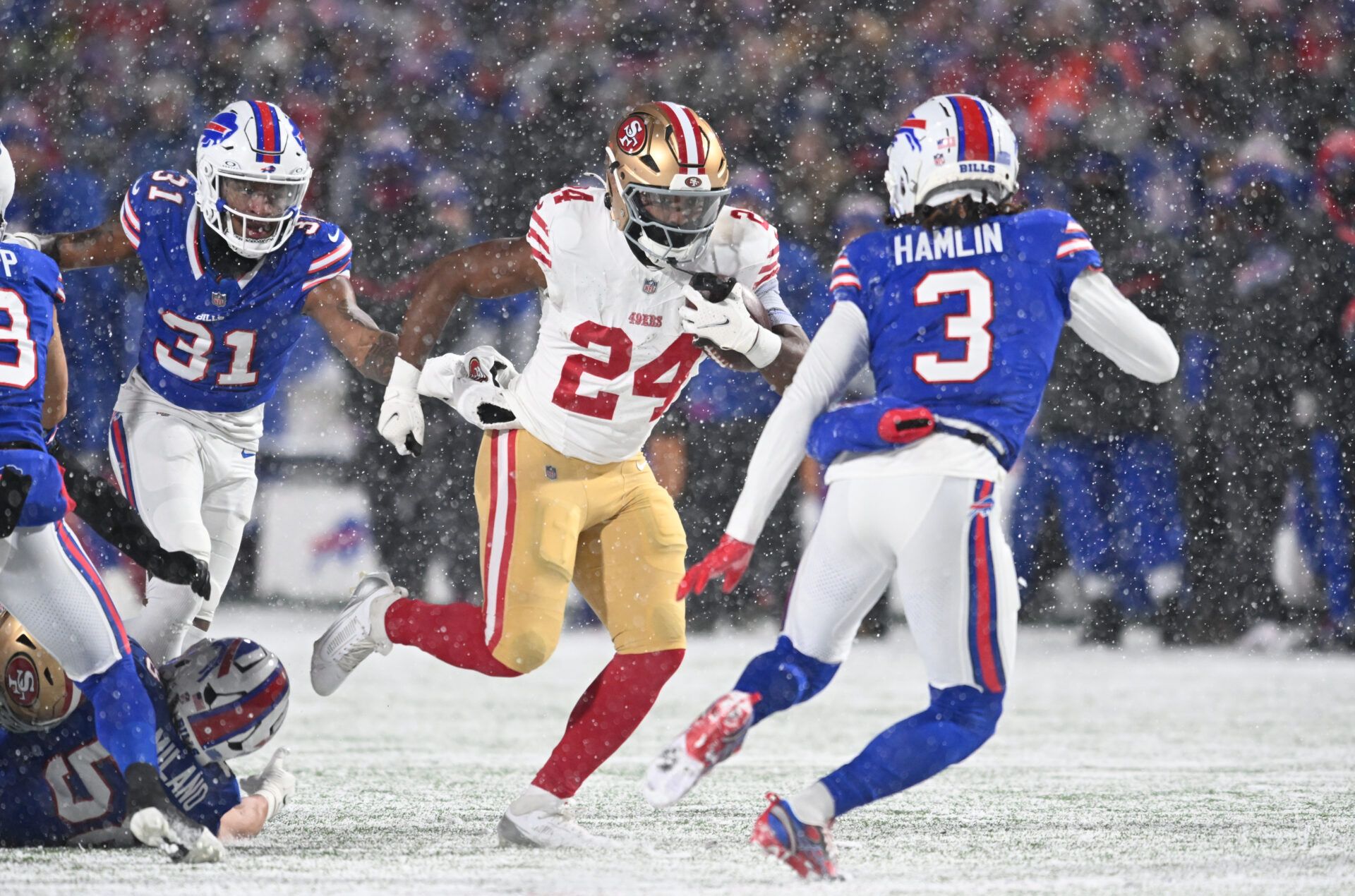 San Francisco 49ers running back Jordan Mason (24) prepares for contact by Buffalo Bills safety Damar Hamlin (3) in the first quarter at Highmark Stadium.